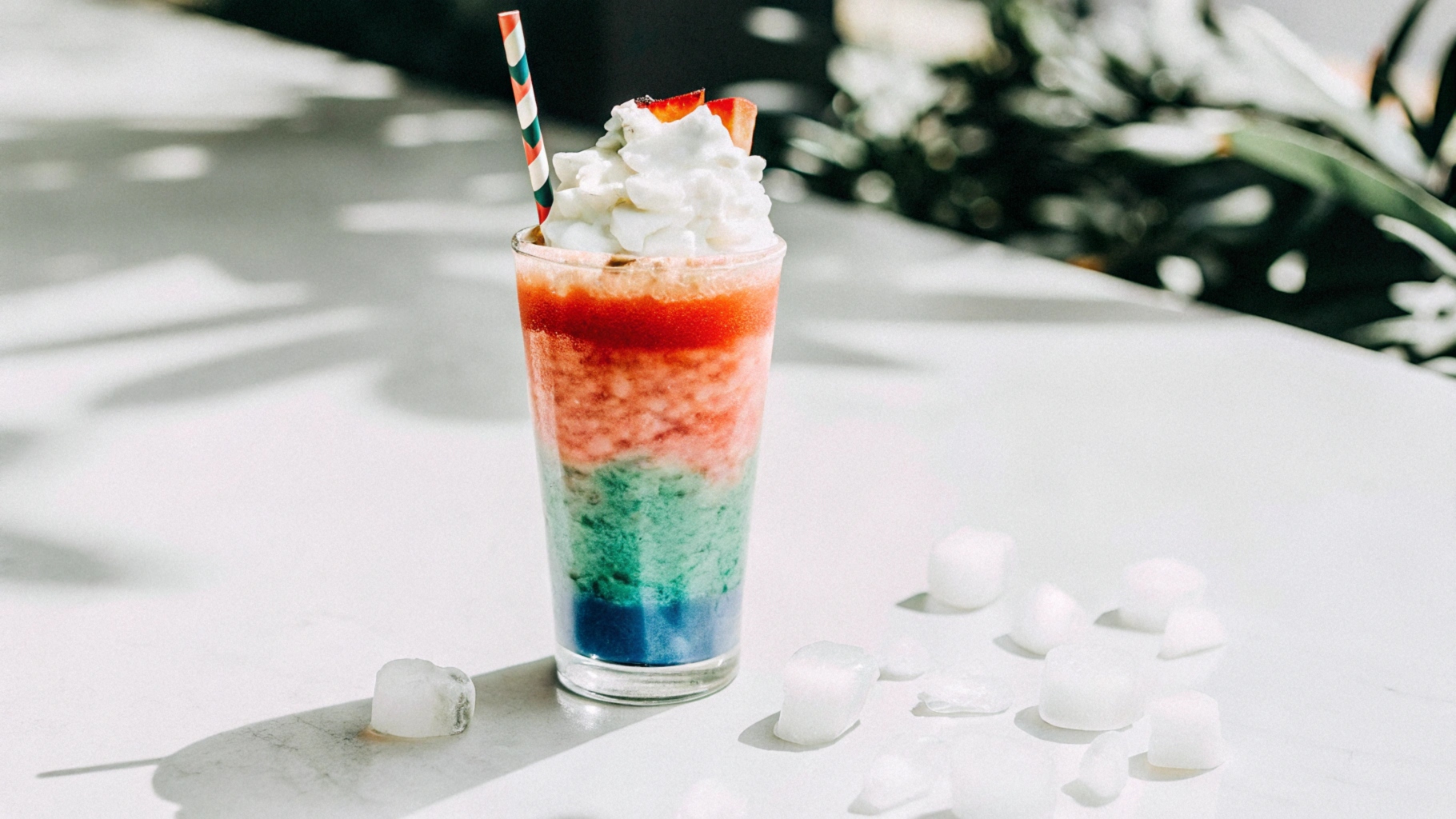 A family enjoying homemade slushies on a sunny patio, with vibrant drinks, fresh fruit slices, and playful decorations in the background