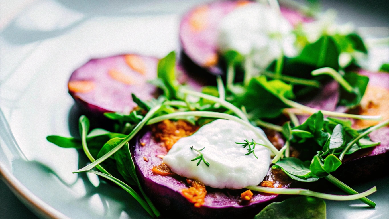 A plate of vibrant purple sweet potato gnocchi, elegantly arranged, garnished with fresh sage leaves, and dusted with parmesan cheese