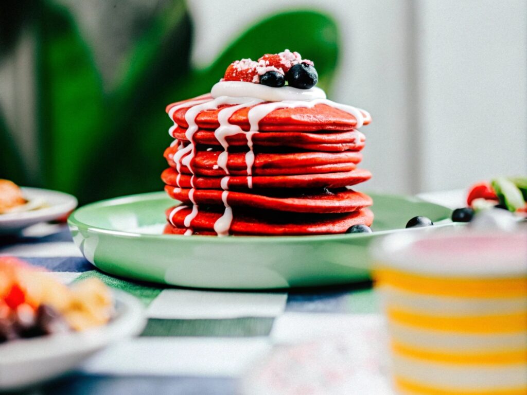 A breakfast table featuring upgraded pancakes, including fluffy American pancakes, delicate crêpes, and thick soufflé pancakes, showing ideas for what to add to boxed pancake mix.