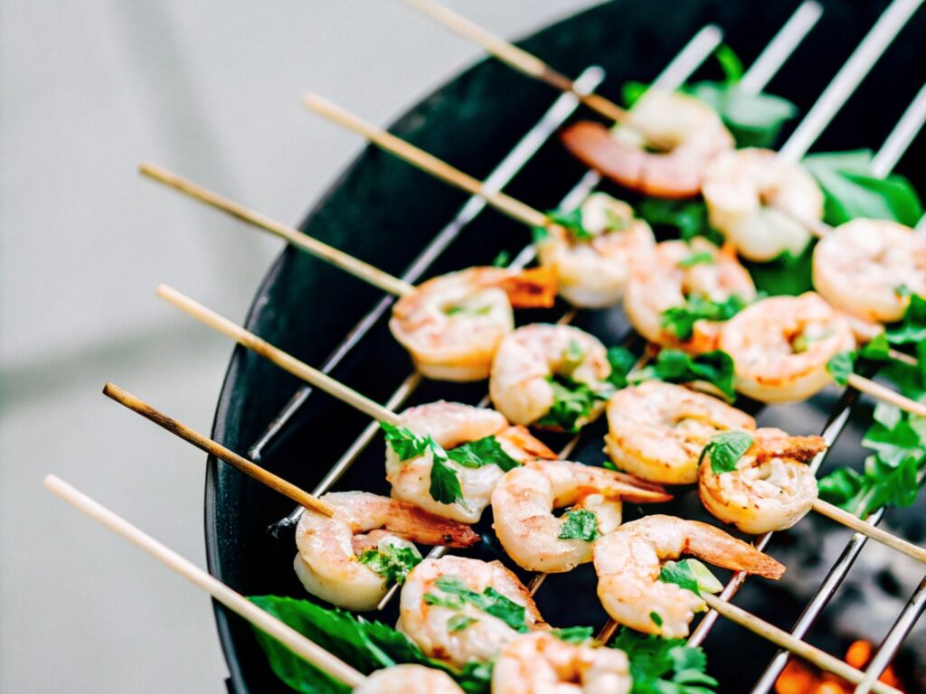 Shrimp skewers with shell-off shrimp, coated in a golden garlic butter marinade, sizzling on the grill