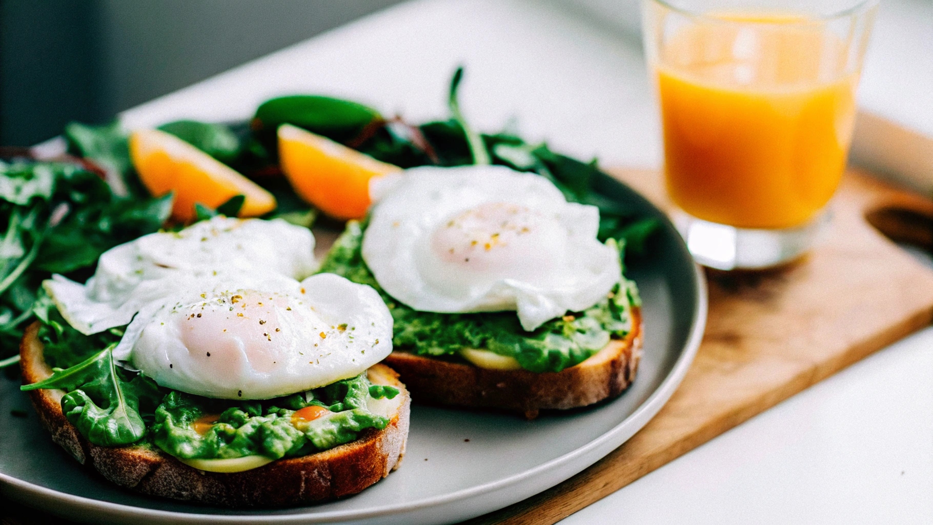 Poached eggs on avocado toast with greens, representing the health benefits of eating eggs for breakfast