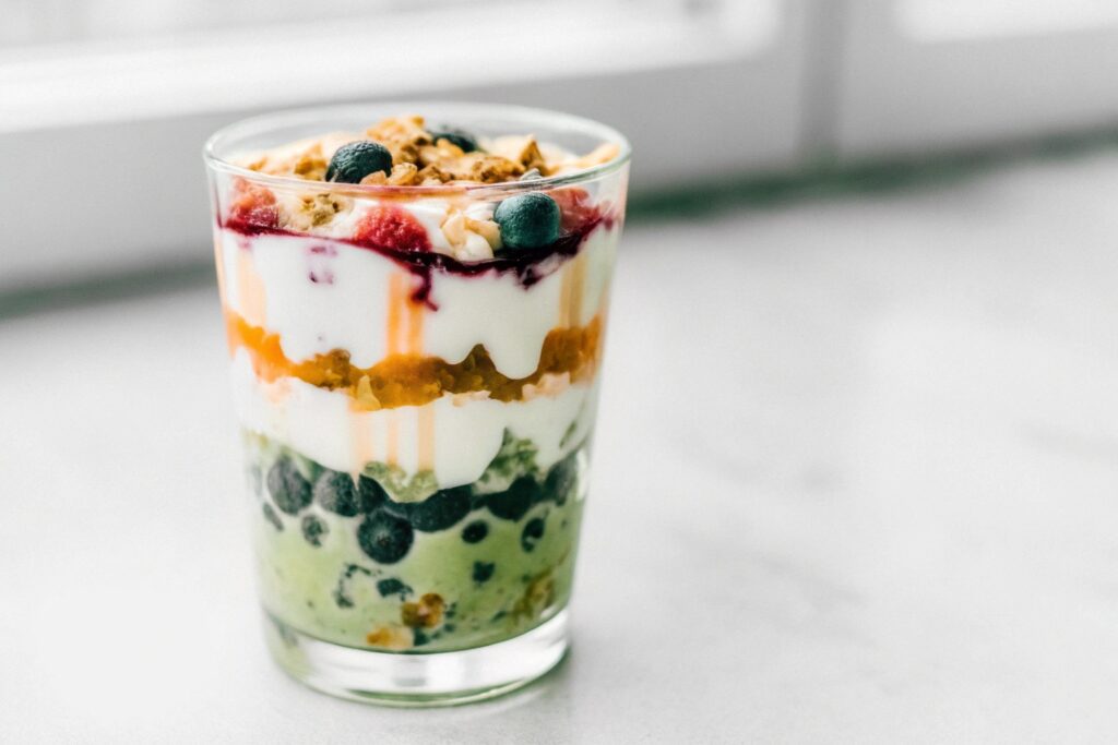 A breakfast parfait featuring layers of yogurt, granola, and fresh berries, a delicious dessert option for breakfast