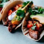 Chipotle-style steak served in tacos, burrito bowls, and with pineapple salsa on a colorful spread