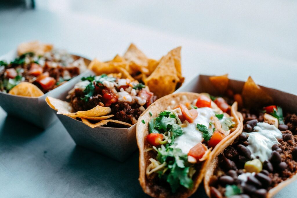 A colorful spread of dishes, including tacos, burrito bowls, and nachos, all made with Chipotle-inspired ground beef and fresh toppings