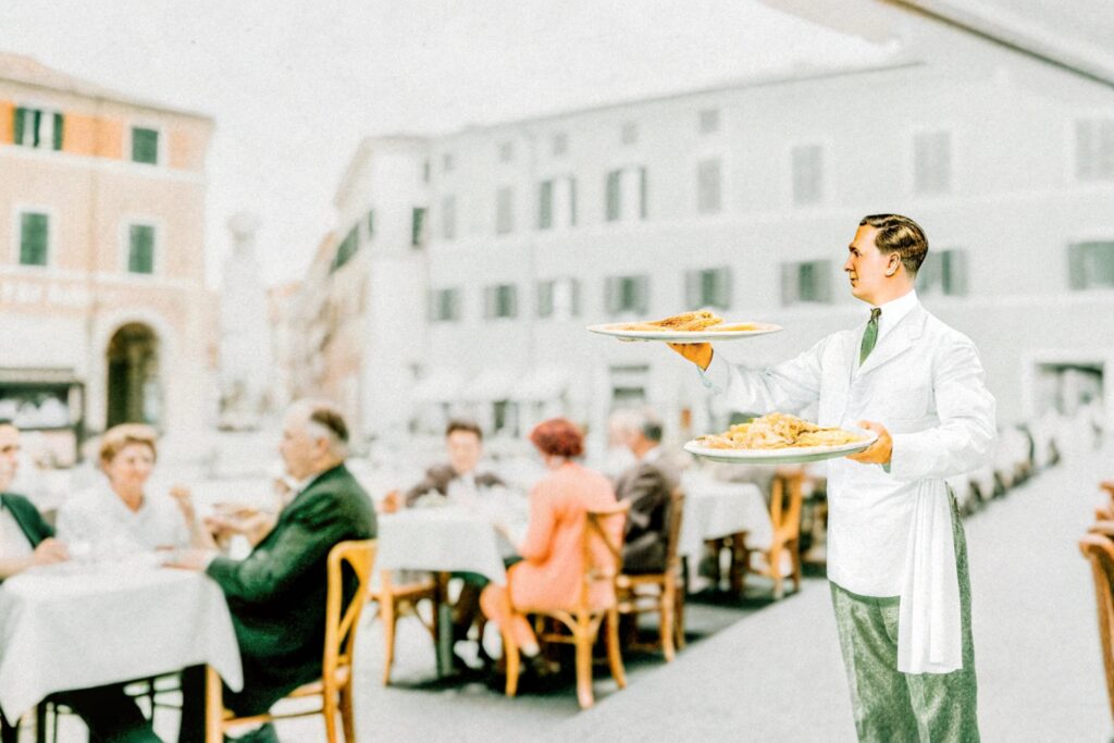 A vintage-style illustration of Alfredo di Lelio serving his famous dish in a bustling Roman restaurant, with diners enjoying their meals