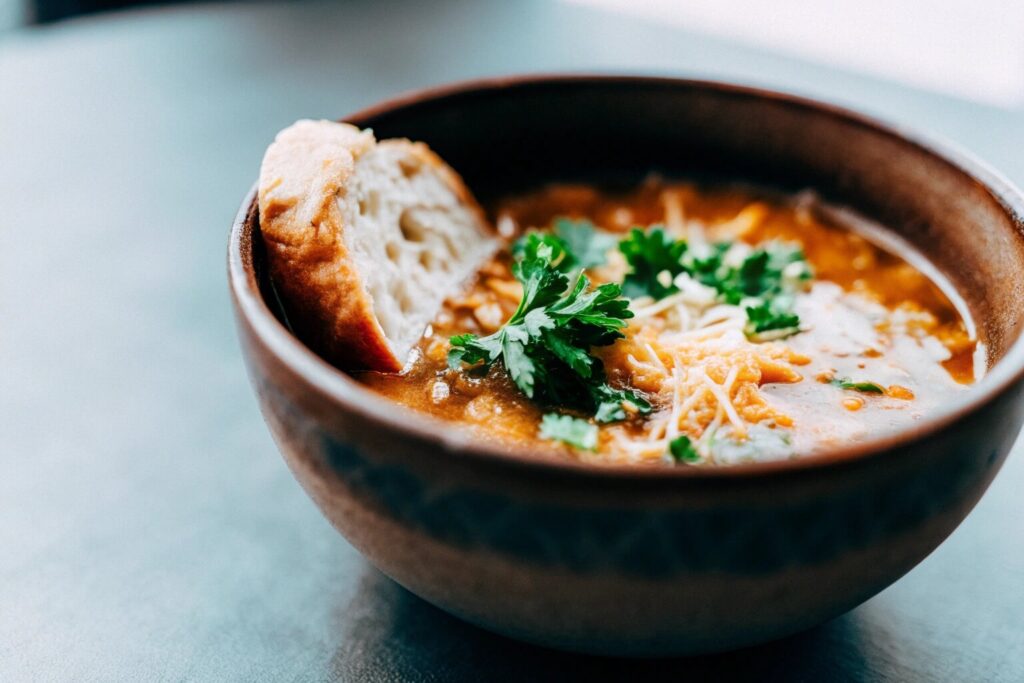 a-steaming-bowl-of-swamp-soup-garnished-with-fresh